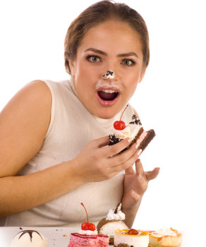Young beautiful women eating cake with cherry